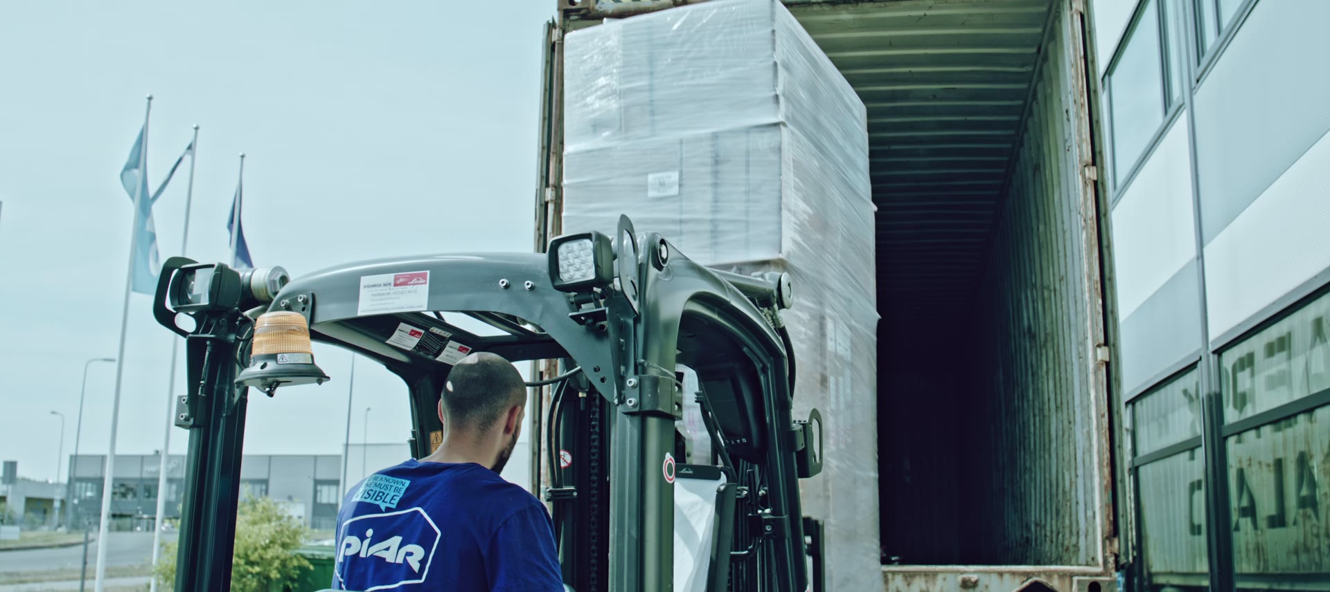 A forklift loading pallets of flat-packed displays into a truck at the Piar warehouse.